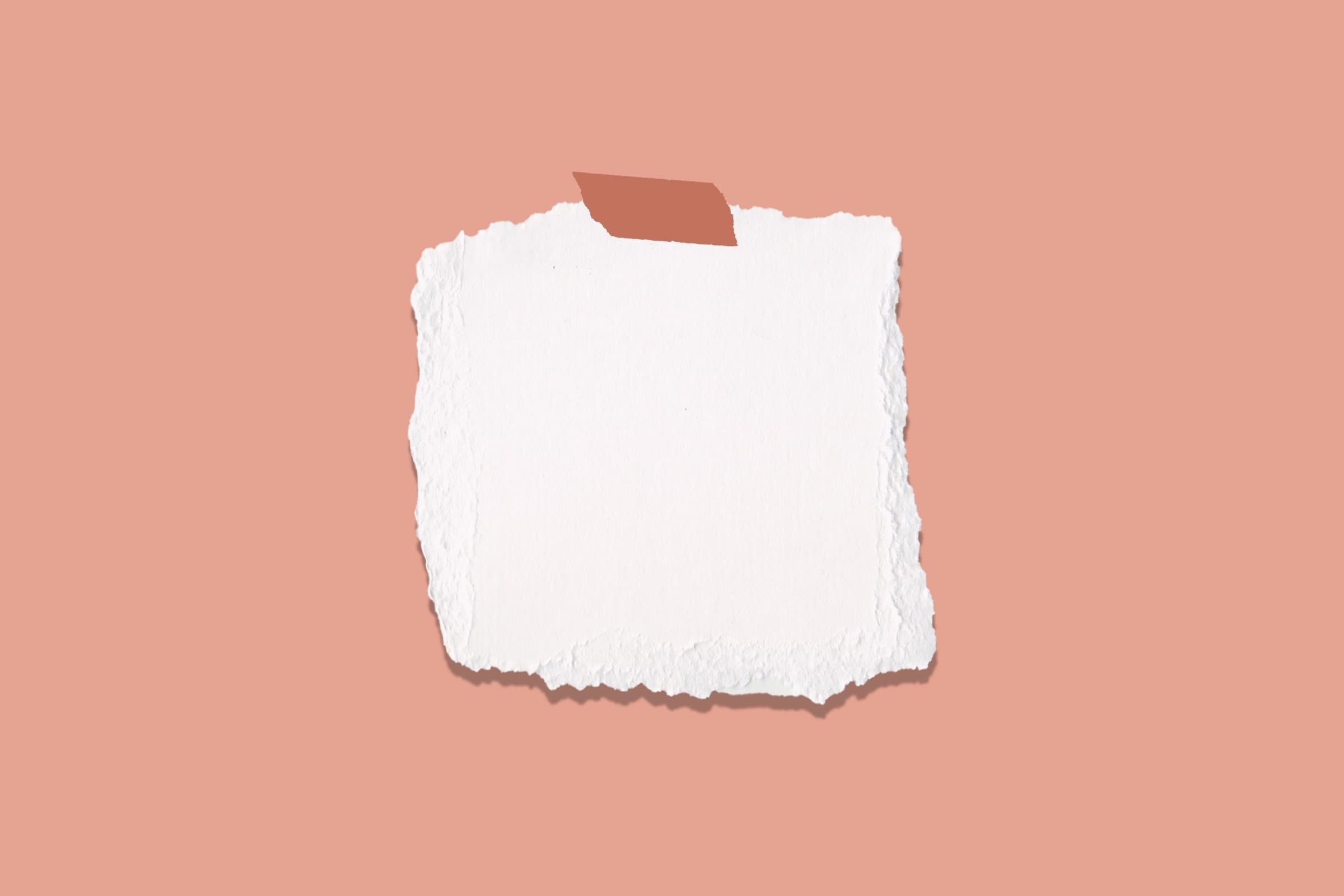A torn paper note taped to a coral background